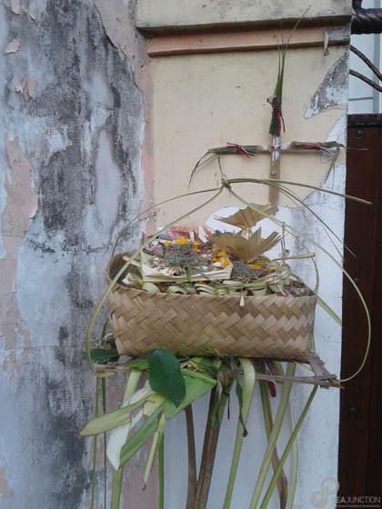 A bamboo basket filled with offerings in front of the bamboo cross.  (Photo by Garrett Kam)