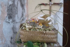 A bamboo basket filled with offerings in front of the bamboo cross.  (Photo by Garrett Kam)